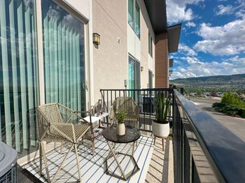 Private balcony with wicker furniture and city views